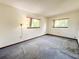 Bedroom with gray carpet, two windows and simple lamp at 11027 Sw 75Th Ave, Ocala, FL 34476