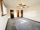 Spacious bedroom with ceiling fan, carpet, and ample natural light at 11027 Sw 75Th Ave, Ocala, FL 34476
