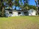 Well-maintained single-story home with a spacious front yard and an attached garage at 11027 Sw 75Th Ave, Ocala, FL 34476