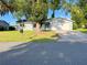 Charming single-story home with a well-manicured lawn and an attached two-car garage at 11027 Sw 75Th Ave, Ocala, FL 34476