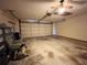 Spacious garage with a ceiling fan, and a roll-up door at 11027 Sw 75Th Ave, Ocala, FL 34476