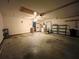 Spacious garage with a ceiling fan, a roll-up door, and room for storage at 11027 Sw 75Th Ave, Ocala, FL 34476