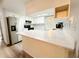 Kitchen island with marble countertop, stainless steel appliances, and white cabinets at 11027 Sw 75Th Ave, Ocala, FL 34476
