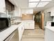 Modern kitchen with stainless steel appliances, marble counters, and white cabinets at 11027 Sw 75Th Ave, Ocala, FL 34476