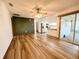 Bright living area features wood floors, sliding glass doors and an open concept kitchen at 11027 Sw 75Th Ave, Ocala, FL 34476