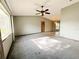 Inviting living room with carpet flooring, ceiling fan, and a view of the dining area at 11027 Sw 75Th Ave, Ocala, FL 34476