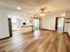 Open-concept living room featuring wood flooring and a ceiling fan with light fixtures at 11027 Sw 75Th Ave, Ocala, FL 34476
