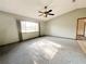 Bright living room features a ceiling fan and ample natural light from the large window at 11027 Sw 75Th Ave, Ocala, FL 34476
