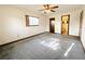 Bedroom features carpet, ceiling fan, a window, and an ensuite bathroom entrance at 11027 Sw 75Th Ave, Ocala, FL 34476