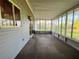 Enclosed back porch with vinyl flooring and view of yard at 11027 Sw 75Th Ave, Ocala, FL 34476