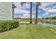 Lush backyard with manicured lawn and serene water views at 487 Midway Dr # B, Ocala, FL 34472
