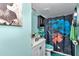 Small updated bathroom featuring a white sink cabinet, black fixtures, and blue accents at 487 Midway Dr # B, Ocala, FL 34472