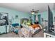 This bedroom has blue walls, ceiling fan, queen bed, silver headboard and small workspace at 487 Midway Dr # B, Ocala, FL 34472