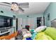 This is a light blue bedroom with a ceiling fan, a TV and two closets at 487 Midway Dr # B, Ocala, FL 34472