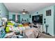 Bright bedroom with a large bed, modern lighting, blue walls and a TV at 487 Midway Dr # B, Ocala, FL 34472