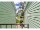 View between condos showcasing street with mature trees and landscaping at 487 Midway Dr # B, Ocala, FL 34472