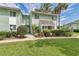 Inviting condo with manicured lawn, mature trees, and charming curb appeal at 487 Midway Dr # B, Ocala, FL 34472