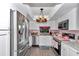 Bright kitchen with stainless steel appliances, white cabinets, and unique lighting fixture providing a cozy and stylish space at 487 Midway Dr # B, Ocala, FL 34472