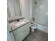 Bathroom features granite vanity, white cabinets, shower, and toilet at 15433 Sw 47Th Avenue Rd, Ocala, FL 34473