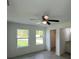 A bright bedroom featuring a ceiling fan and gray wood-look flooring at 15433 Sw 47Th Avenue Rd, Ocala, FL 34473