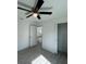 Bedroom featuring ceiling fan, gray wood flooring, and closet at 15433 Sw 47Th Avenue Rd, Ocala, FL 34473