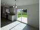 Dining area with modern light fixture adjacent to the sliding door at 15433 Sw 47Th Avenue Rd, Ocala, FL 34473