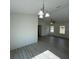 Bright dining area with stylish chandelier, neutral walls, and adjacent living room at 15433 Sw 47Th Avenue Rd, Ocala, FL 34473