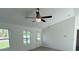 Bright living room with a ceiling fan and a view through two windows at 15433 Sw 47Th Avenue Rd, Ocala, FL 34473