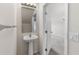 Cozy powder room featuring a pedestal sink and bright lighting, conveniently located near the entry at 4426 Sw 49Th Ave, Ocala, FL 34474