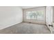 A bright bedroom with neutral carpet, a large window and a simple design at 4426 Sw 49Th Ave, Ocala, FL 34474