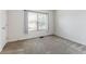 A spacious bedroom with a large window and neutral-toned carpeting at 4426 Sw 49Th Ave, Ocala, FL 34474