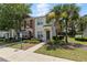 Charming townhouse with a well-manicured lawn, lush landscaping and mature palm trees at 4426 Sw 49Th Ave, Ocala, FL 34474