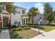 Attractive townhouse featuring a covered entryway, manicured landscaping, and proximity to accessible parking at 4426 Sw 49Th Ave, Ocala, FL 34474