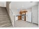 A functional kitchen with white appliances and wood cabinets adjacent to carpeted stairs at 4426 Sw 49Th Ave, Ocala, FL 34474