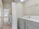 An upper floor laundry area with a modern washer and dryer, and wire shelving at 4426 Sw 49Th Ave, Ocala, FL 34474
