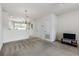Comfortable living room with neutral carpeting, seamlessly connected to the adjacent kitchen at 4426 Sw 49Th Ave, Ocala, FL 34474