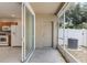 View of a screened patio with access to a storage closet and a glimpse of the kitchen at 4426 Sw 49Th Ave, Ocala, FL 34474