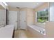 Bright bathroom with soaking tub, window and vanity at 9879 Sw 38Th Ave, Ocala, FL 34476