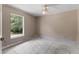 A bare bedroom with a ceiling fan and a window offers natural lighting at 9879 Sw 38Th Ave, Ocala, FL 34476