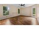 Large bedroom with wood flooring, ceiling fan and natural light from large windows at 9879 Sw 38Th Ave, Ocala, FL 34476