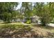 Single-story home featuring lush landscaping, a charming front entrance, and a convenient two-car garage at 9879 Sw 38Th Ave, Ocala, FL 34476