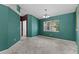 Large room with bare floors, an interior window, and an open door to the other rooms in the home at 9879 Sw 38Th Ave, Ocala, FL 34476