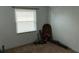 This bedroom has a window and beige colored walls and carpet at 32932 Crooked Oaks Ln, Leesburg, FL 34748