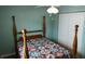 Bright bedroom with a four-poster bed, quilt, and ample closet space at 32932 Crooked Oaks Ln, Leesburg, FL 34748