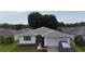 Charming single-story home featuring a well-maintained lawn and an attached one car garage at 32932 Crooked Oaks Ln, Leesburg, FL 34748