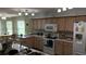 Well-equipped kitchen featuring sleek countertops, modern appliances, and a cozy breakfast nook at 32932 Crooked Oaks Ln, Leesburg, FL 34748