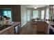 Functional kitchen and dining area with hardwood floors and modern stainless steel appliances at 32932 Crooked Oaks Ln, Leesburg, FL 34748