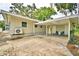 Rear exterior shows a covered parking area, outdoor seating, and the home's back entrance at 103 13Th Se St, Winter Haven, FL 33880