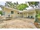 Rear exterior shows a covered parking area, outdoor seating, and the home's back entrance at 103 13Th Se St, Winter Haven, FL 33880