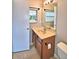 Bathroom with a single sink vanity, framed mirror, and a toilet at 103 13Th Se St, Winter Haven, FL 33880